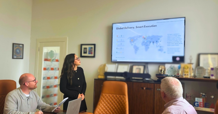 PG Paper UK Sales Team presenting in the boardroom with a slide titled Global Delivery, Smart Execution