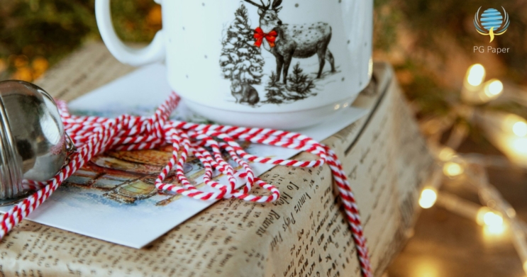 kraft paper wrapping christmas gift in red and white ribbon