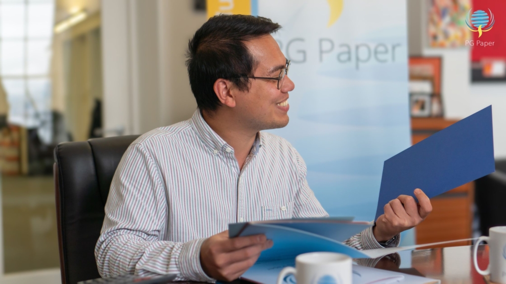 PG Paper's Finance Executive Pat Fransico looking at coloured paper samples